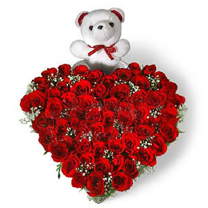 Heart Shape Arrangement of 50 Red roses with small cute teddy cake delivery Delhi